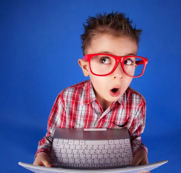 Маленький мальчик с ноутбуком, концепция компьютерной наркомании — стоковое фото