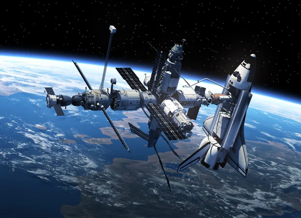 Шаттл и космическая станция в космосе — стоковое фото